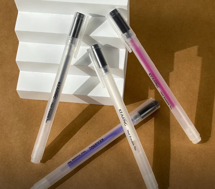 four colors of heat ersable pens red white black and blue